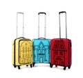 Different suitcases with drawings of houses on white background. Moving concept