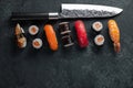 Different Sushi with Japanese knife on concrete Royalty Free Stock Photo