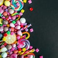 different sweets on a black background, candy, chewing gum, candy, marshmallows