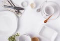 Different tableware and dishes on the white background, top view. Royalty Free Stock Photo