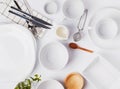 Different tableware and dishes on the white background, top view. Royalty Free Stock Photo