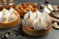 Different tartlets on dark grey table, closeup. Tasty dessert