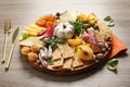 Different tasty appetizers served on wooden table