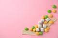 Different tasty chewing gums on pink background, flat lay. Space for text Royalty Free Stock Photo