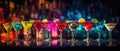 Different tasty cocktails on dark background. Beautiful line of three colorful alcoholic cocktails on a bar in a