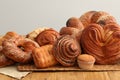 Different tasty freshly baked pastries on wooden table