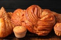 Different tasty freshly baked pastries on table, closeup