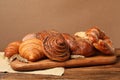 Different tasty freshly baked pastries on wooden table