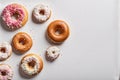 Different tasty glazed donuts on white background. Sweet food, calories, holiday, birthday.