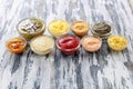 Different tasty sauces in bowls on wooden table