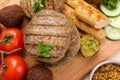 Different tasty vegan meat products and fresh vegetables on wooden board, flat lay Royalty Free Stock Photo