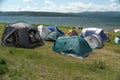 Different tents are on the shore of the  Large lake in the summer season Royalty Free Stock Photo