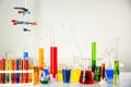 Different test tubes and laboratory glassware with colorful liquids on table against light background Royalty Free Stock Photo