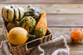 Different Thanksgiving Mini Pumpkins on a rustic wooden table. Thanksgiving concept. Autumn, Harvest wicker basket Royalty Free Stock Photo