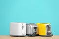 Different toasters on table color background. Interior element Royalty Free Stock Photo