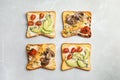 Different toasts with avocado, cherry tomatoes, mushrooms and chia seeds on grey background