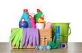 Different toilet cleaning tools and crate on wooden table against white background Royalty Free Stock Photo