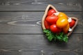 Different tomatoes in wooden plate