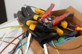 Different tools and cables in paper indoors. Installation of electrical wiring Royalty Free Stock Photo