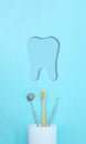 Different tools for dental care, toothbrush in plastic glass and molar tooth paper cut icon. Tooth symbol sign. Dental background