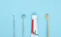 Different tools for dental care, toothbrush and toothpaste on blue Dental background. With copy space, close-up. Oral dental Royalty Free Stock Photo