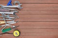 Different tools on a wooden plank background with copy space Royalty Free Stock Photo
