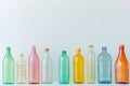 Different transparent plastic bottles on light background. Colorful plastic bottles of various sizes and shapes standing in a row