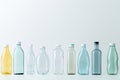 Different transparent plastic bottles on light background. Colorful plastic bottles of various sizes and shapes standing in a row