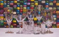 DIFFERENT TYPE OF DRINKING GLASSES SITTING COLORFUL TABLE Royalty Free Stock Photo