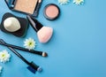 Different type of makeup brush sponge eye shadow and blusher with white flowers on blue background. Generative AI Royalty Free Stock Photo