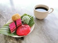 Different type of Malaysian traditional cake or kuih-muih served on plate with a cup of coffee on the table. Royalty Free Stock Photo