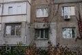 Different types Balconies and windows entwined with red ivy leaves in an old panel house. Facade Soviet apartment Royalty Free Stock Photo