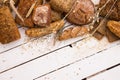 Different types of bread on white wooden board Royalty Free Stock Photo
