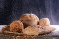 Different types of bread from whole grain, gluten-free flour on a wooden table on a dark background