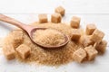 Different types of brown sugar on white table, closeup Royalty Free Stock Photo