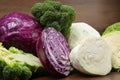 Different types of cabbage on wooden table, closeup Royalty Free Stock Photo