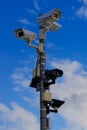 Multiple security cameras on pole and blue sky