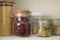 Different types of cereals, seeds and legumes in containers on white table, closeup Royalty Free Stock Photo