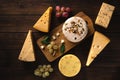 Different types of cheese on a cutting board top view