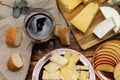 Different types of cheese on a rustic wooden cutting board with a sliced apple and a glass of wine. Top view Royalty Free Stock Photo