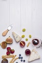 Different types of cheeses with wine glass and fruits Royalty Free Stock Photo