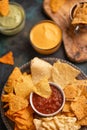 Different types of chips with dressings and dip and salsa, close-up, rest with beer, snacks Royalty Free Stock Photo