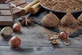 Different types of chocolate, cocoa powder, hazelnuts and other spices.