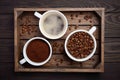 Different types of coffee - ground, grain and beverage on dark wooden background Royalty Free Stock Photo