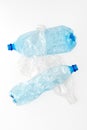 Different types of crushed plastic bottles on white background. Recyclable waste. Recycling, reuse, garbage disposal, resources, e