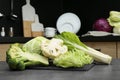 Different types of cut cabbage on grey table in kitchen Royalty Free Stock Photo