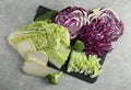 Different types of cut cabbage on light grey table, flat lay Royalty Free Stock Photo
