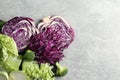Different types of cut cabbage on light grey table, flat lay. Space for text Royalty Free Stock Photo