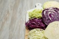 Different types of cut cabbage on white wooden table, space for text Royalty Free Stock Photo