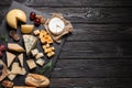 Different types of delicious cheese on black wooden table, top view. Space for text Royalty Free Stock Photo